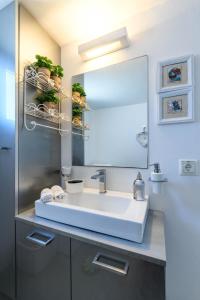 a bathroom with a sink and a large mirror at Ornos Beach House in Ornos