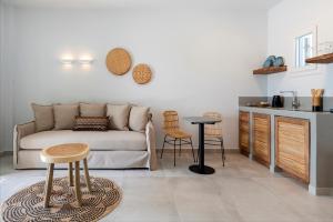 a living room with a couch and a table and chairs at Drios Luxury Studios in Drios