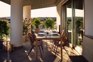 a dining table and chairs on a balcony with a view at La Furibonda in Fano