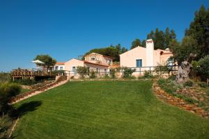 a large lawn in front of a house at Monte Soalheiro in Zambujeira do Mar