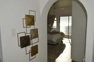 a room with a bed and a wall with pictures on it at Harbourview Lodge in Gordonʼs Bay