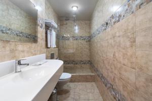 a bathroom with a sink and a toilet at AVS Hotel in Yekaterinburg