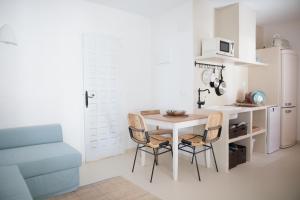 a kitchen with a table and chairs and a refrigerator at Quinta la Sal in Jávea