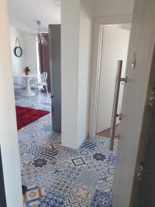a hallway with a blue and white tile floor at Muring Apartments in Tribunj +34 photos