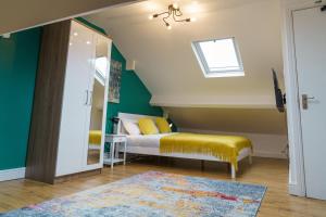 a bedroom with a bed with yellow cushions and a window at Emerald Rooms Bolton by Prime Stay in Bolton