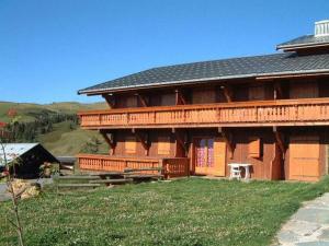 a large wooden house on top of a hill at Studio Hauteluce, 1 pièce, 2 personnes - FR-1-293-184 in Hauteluce