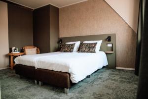 מיטה או מיטות בחדר ב-Hoeve te Gast - vakantieboerderij
