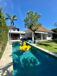 a yellow rubber duck floating in a swimming pool at Villa EMMA | heart of Seminyak | 350m Beach in Seminyak