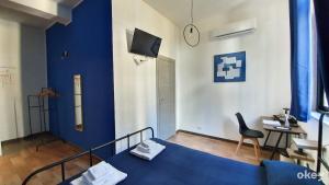 a blue bedroom with a bed and a chair at I Covi Del Viaggiatore - Bari Politecnico in Bari