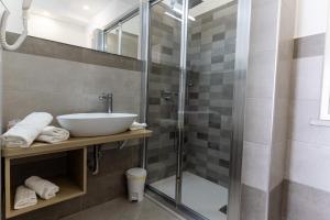 a bathroom with a sink and a shower at Teddu B&B in Giardini Naxos