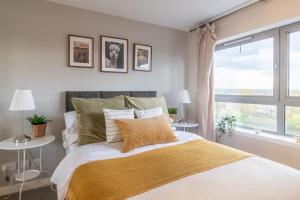 een slaapkamer met een groot bed en een raam bij Luxury Riverview City Centre Apartment in Glasgow