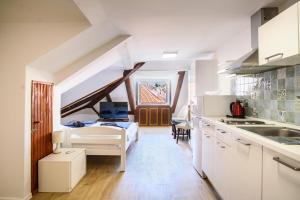 a kitchen and living room with a sink and a desk at Clarinet Old Town Dubrovnik in Dubrovnik