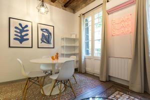 een eetkamer met een tafel en stoelen en een raam bij Stay Unique Apartments Corsega in Barcelona