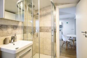 a bathroom with a sink and a shower at Clarinet Old Town Dubrovnik in Dubrovnik +37 photos