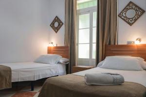 Postel nebo postele na pokoji v ubytování Hostal Colón