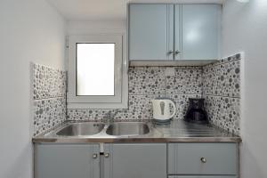 a kitchen with a sink and a mirror at Urban Studios Manos in Chania Town +32 photos