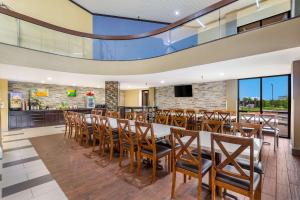 a dining room with a long table and chairs at Quality Inn & Suites Florence - Cincinnati South in Florence