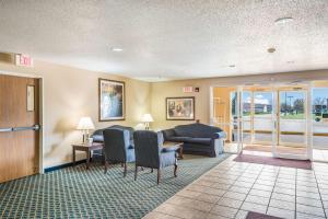 a living room with a couch and a table and chairs at Quality Inn & Suites Eldridge Davenport North in Eldridge