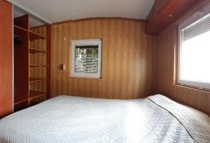a small bedroom with a bed and a window at Twój wypoczynek in Augustów