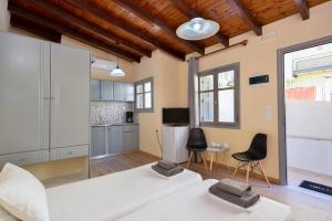 a living room with a large white bed and chairs at Urban Studios Manos in Chania Town