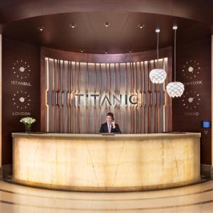 a man standing in front of a large glass door at Titanic Business Kartal in Istanbul
