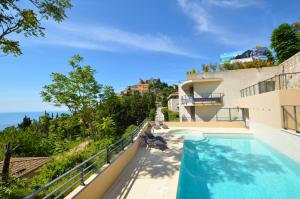 a view from the balcony of a house with a swimming pool at La Perle d'Eze - Aparthotel in Èze