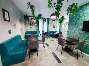 a restaurant with a blue couch and tables and chairs at VerTe in Techirghiol