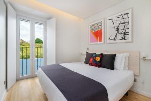 Un dormitorio con una cama y una ventana grande. en WHome Lisbon Prime Aparts - BeatoHub, en Lisboa