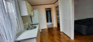 a kitchen with a sink and a couch in a room at Новый дом целиком 800м от моря за городом в тихом уютном месте in Chornomorsk +18 photos