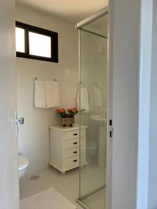 a bathroom with a toilet and a glass shower at Avenida Center Hotel in Uruguaiana +21 photos