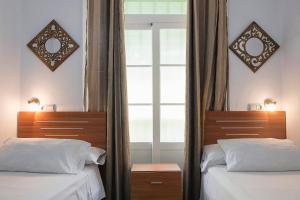 Postel nebo postele na pokoji v ubytování Hostal Colón