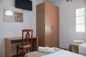Postel nebo postele na pokoji v ubytování Hostal Colón