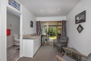 a kitchen with a sink and a toilet in a room at Havenbrooke - Kerikeri Holiday Home in Kerikeri