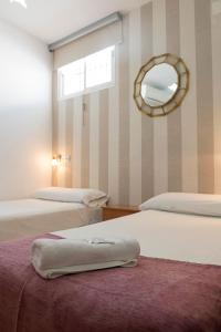 Postel nebo postele na pokoji v ubytování Hostal Colón