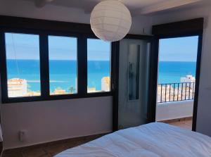 a bedroom with a bed with a view of the ocean at Casa Pepita in Altea