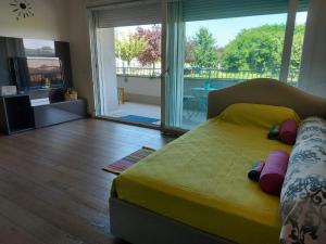 a bedroom with a large bed and a balcony at Bnbook - Metropolitan Expo Flat in Rho