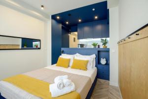 a bedroom with a bed with towels on it at Athenian Sensations Apartments and Suites in the Heart of Athens in Athens