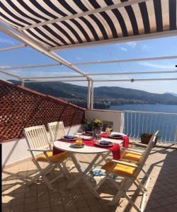 a table and chairs on a balcony with a view of the water at Bella Vista House-Sorrento coast - free parking-solarium in Vico Equense