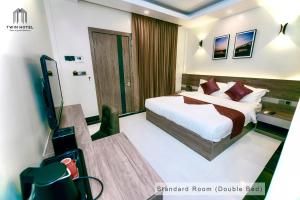 a hotel room with a bed and a television at Twin Hotel in Kampot