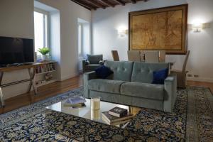 a living room with a couch and a tv at Barberini Apartment in Rome