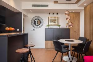 a kitchen and dining room with a table and chairs at V Luxury Apartment in Split