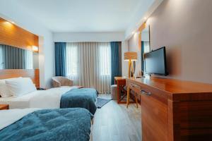 Postel nebo postele na pokoji v ubytování Kilpa Hotel