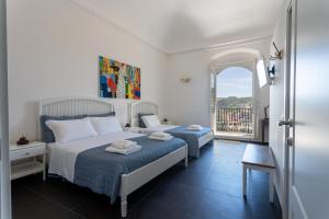 a bedroom with a bed and a window with a view at Bed and Breakfast Terra del Sole Ibla in Ragusa