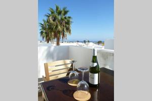 a table with a bottle of wine and two glasses at El Pasadizo - The secret passage-Puerto del Carmen in Puerto del Carmen +14 photos