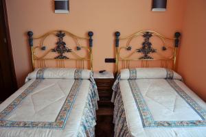 two beds sitting next to each other in a room at Hostal La Corte in Carrión de los Condes