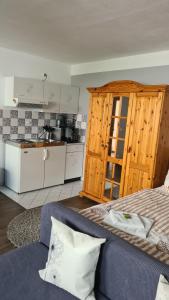 a kitchen and a bed in a room at Pension "Am Fischerweg" in Heringsdorf