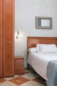 Postel nebo postele na pokoji v ubytování Hostal Colón