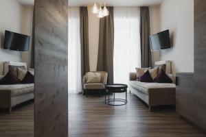 a living room with a couch and a tv at Hotel Sonklarhof in Ridanna