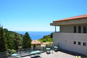 a balcony of a building with a view of the ocean at La Perle d'Eze - Aparthotel in Éze