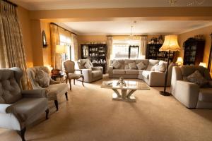 a living room with couches and a coffee table at Station House Bed & Breakfast in Ennistymon